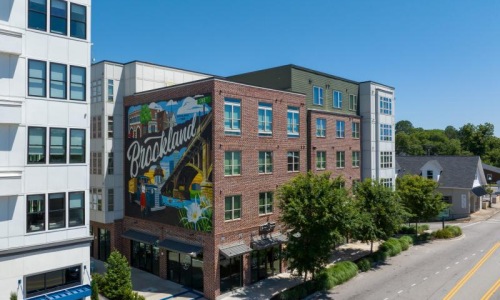 a building with a road and trees