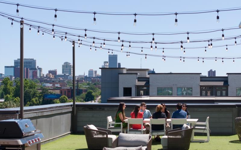 outside lounge area with string lights and community views